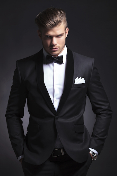 business man holds his hands in his pockets